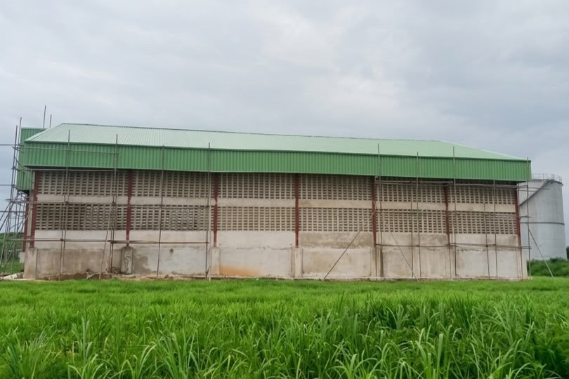 Modern industrial structure with metal siding under a clear sky